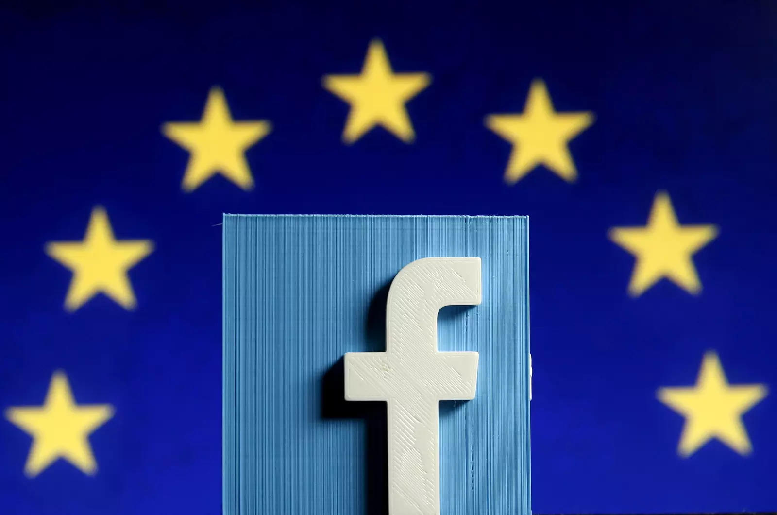 Facebook logo in front of the EU flag